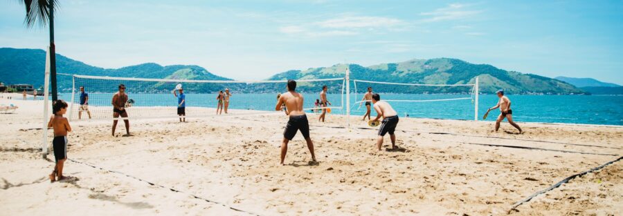 men playing volleyball on sand